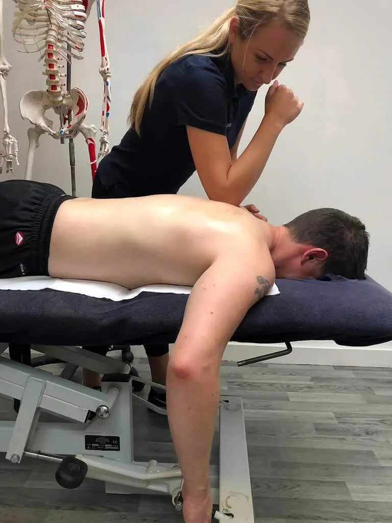 Sports massage being performed on the clients back.